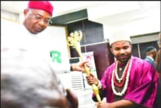 Traditional ruler receiving a staff of office